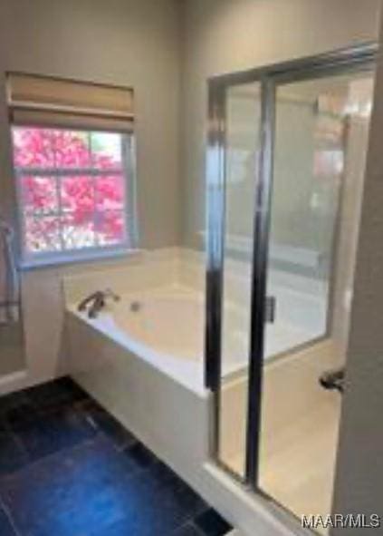 bathroom featuring independent shower and bath and tile patterned flooring