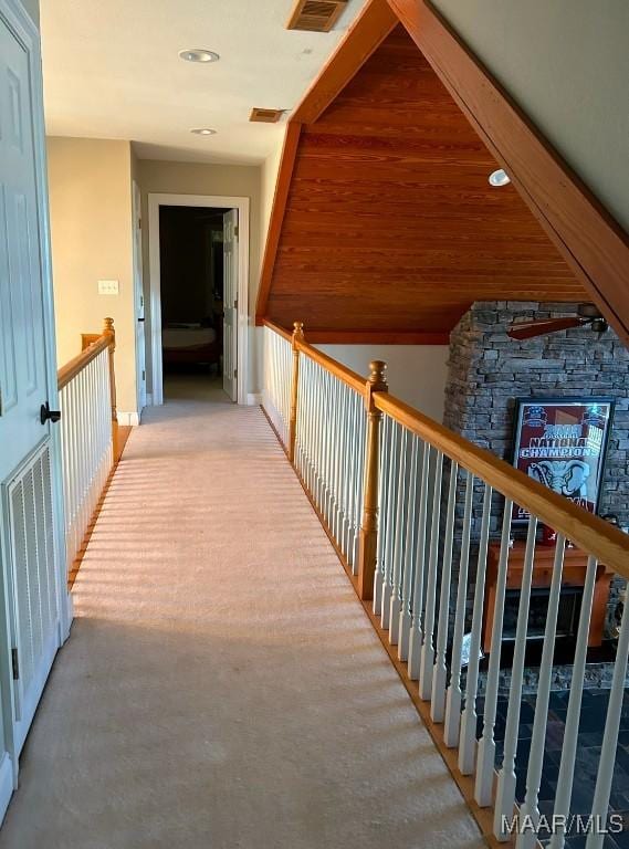 hallway with visible vents, recessed lighting, an upstairs landing, and light colored carpet