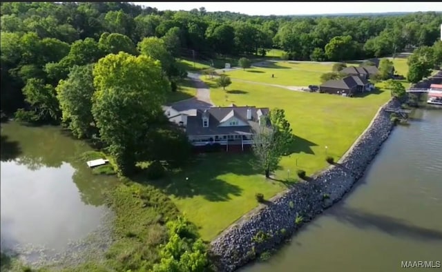 aerial view featuring a wooded view and a water view