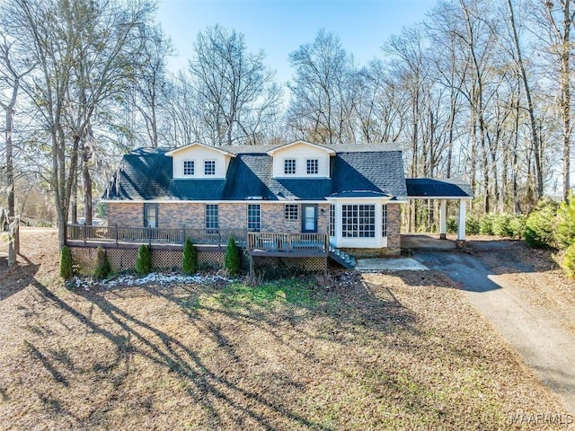 view of front of property with a carport and a deck