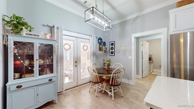 dining room featuring french doors and light wood-type flooring