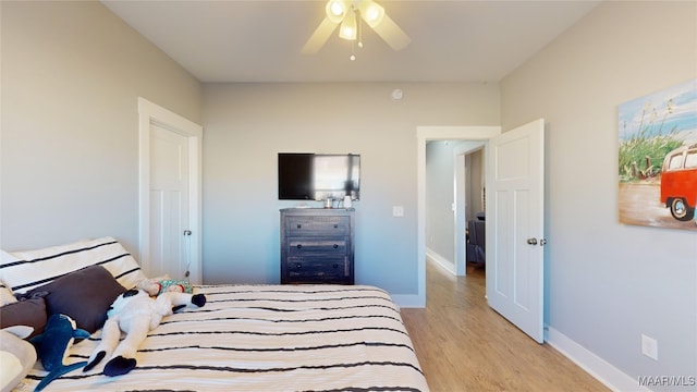 bedroom with ceiling fan and light hardwood / wood-style flooring