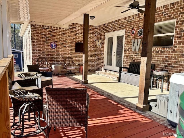 deck featuring a patio, ceiling fan, and french doors