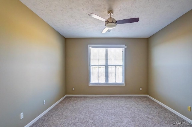 empty room with ceiling fan, a textured ceiling, and carpet