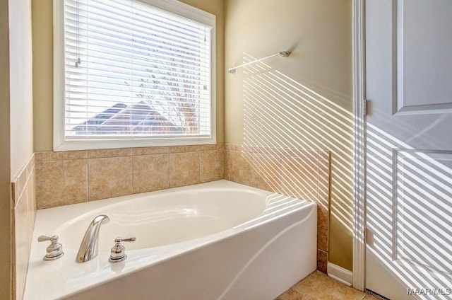 bathroom with tile patterned flooring and a bath