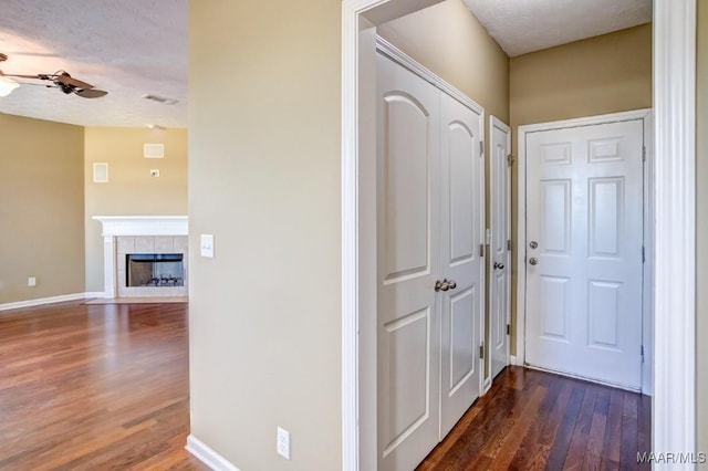 interior space featuring dark wood-type flooring and a textured ceiling