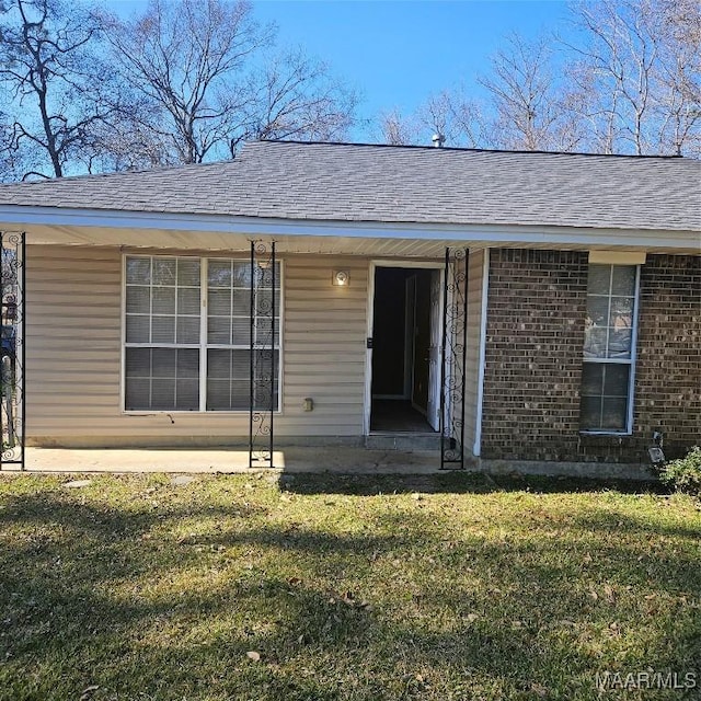 entrance to property with a lawn