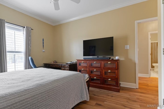 bedroom with ceiling fan, ornamental molding, connected bathroom, and hardwood / wood-style floors