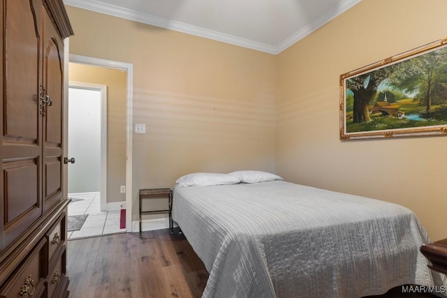 bedroom with hardwood / wood-style flooring and ornamental molding