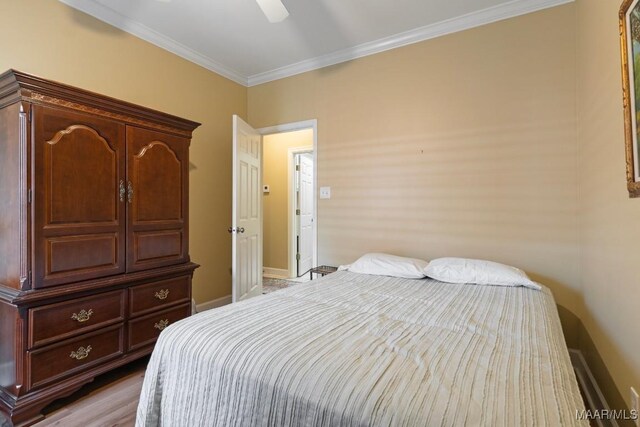 bedroom with ceiling fan and ornamental molding