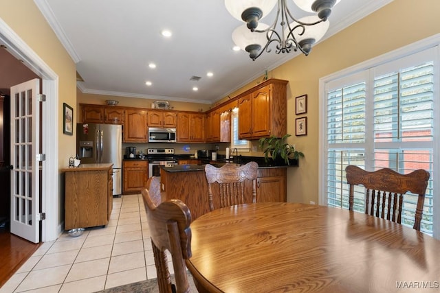 tiled dining area with a notable chandelier and ornamental molding