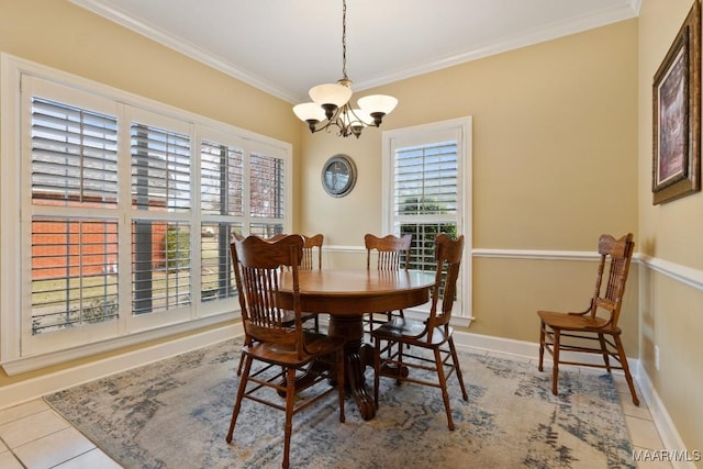 dining area with light tile patterned floors, crown molding, and a notable chandelier