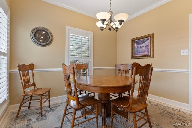 dining area with crown molding and a chandelier