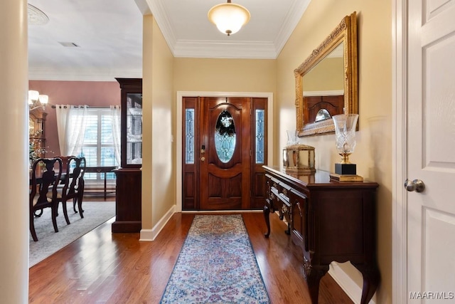 entrance foyer featuring ornamental molding and dark hardwood / wood-style floors