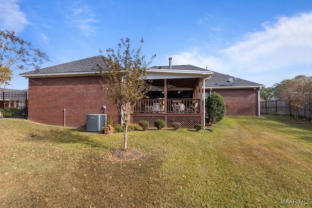 back of house featuring a wooden deck, a yard, and central AC