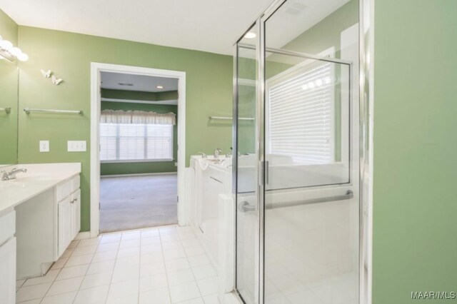 bathroom featuring vanity, a shower with shower door, and tile patterned flooring