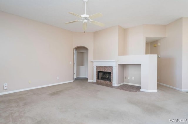 unfurnished living room with ceiling fan and carpet flooring