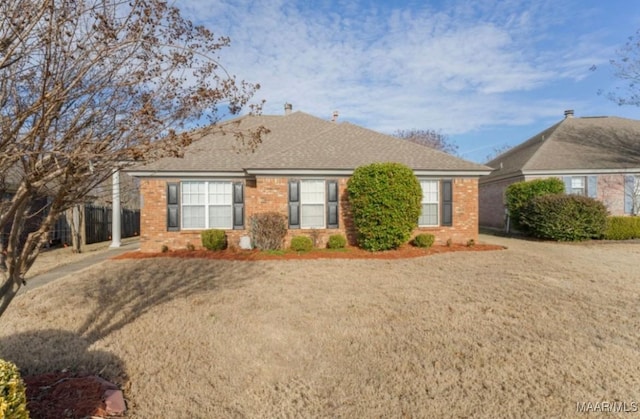 ranch-style home featuring a front yard