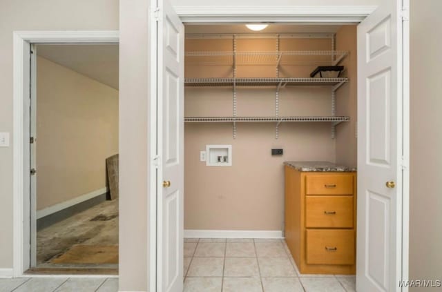 laundry room featuring light tile patterned flooring, hookup for an electric dryer, and hookup for a washing machine