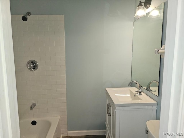 full bathroom featuring vanity, toilet, and tiled shower / bath combo