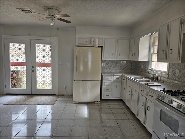 kitchen with white cabinetry, sink, white appliances, and french doors