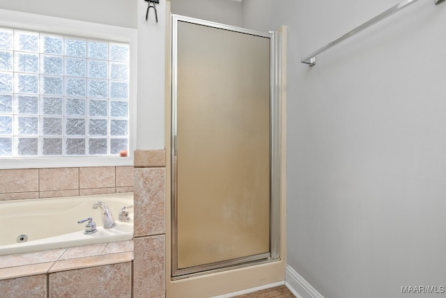 bathroom with separate shower and tub