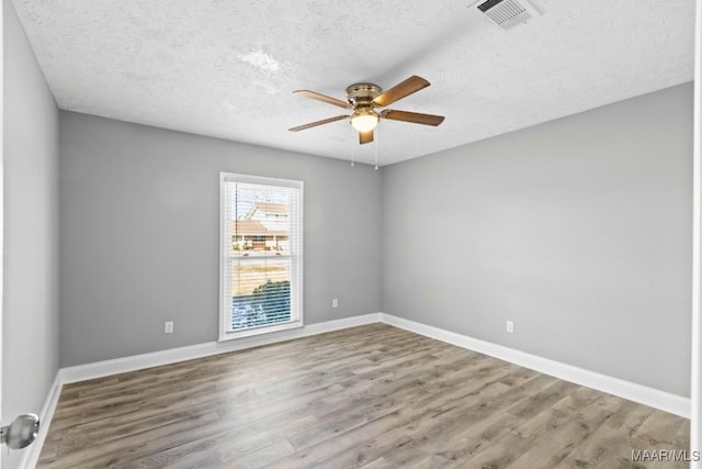 unfurnished room with hardwood / wood-style flooring, a textured ceiling, and ceiling fan