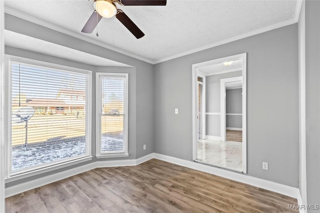 unfurnished room with crown molding, hardwood / wood-style floors, ceiling fan, and a textured ceiling