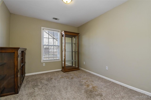 unfurnished bedroom with baseboards, carpet flooring, and visible vents
