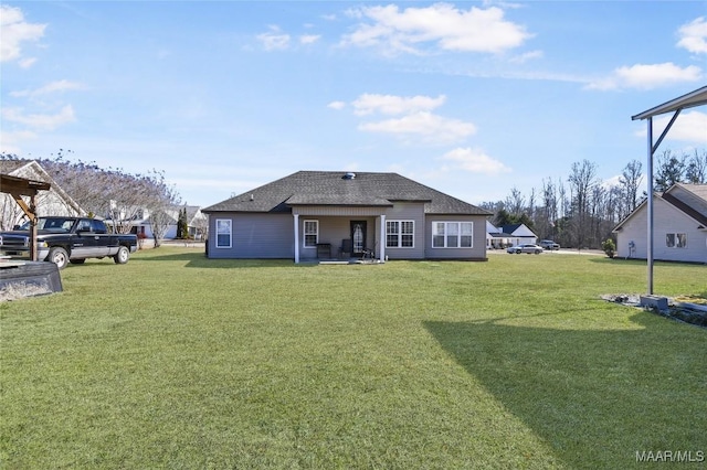 back of house with a lawn