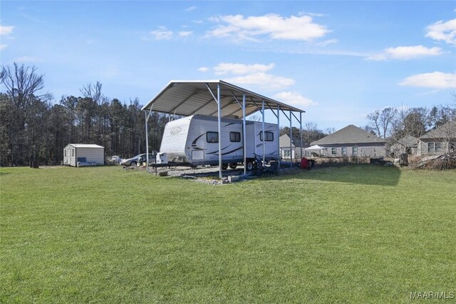 view of yard featuring a carport and a storage unit