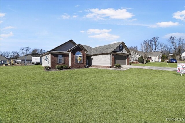 ranch-style house featuring a garage and a front yard