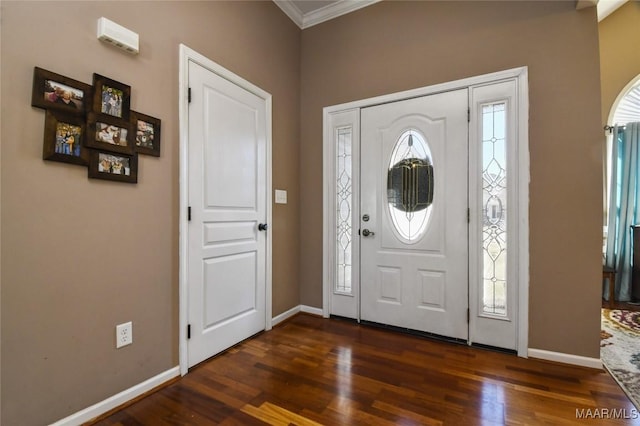 foyer featuring baseboards, dark wood-style floors, and crown molding