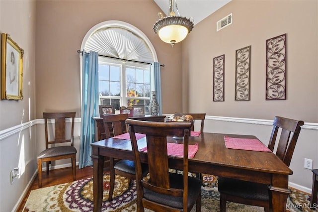 dining room featuring lofted ceiling and hardwood / wood-style floors