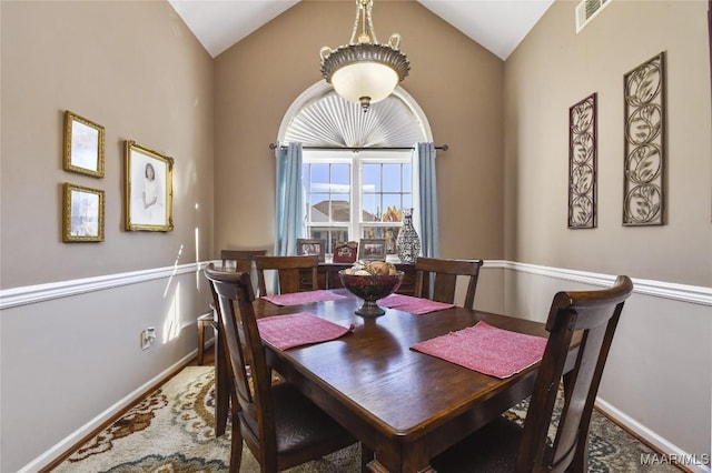 dining area featuring lofted ceiling