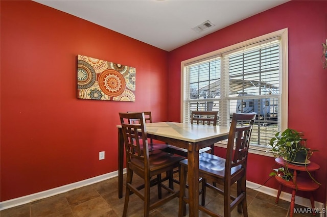 dining space featuring baseboards and visible vents
