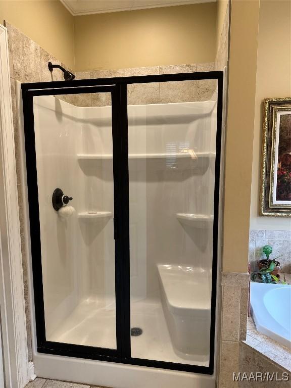 bathroom featuring shower with separate bathtub