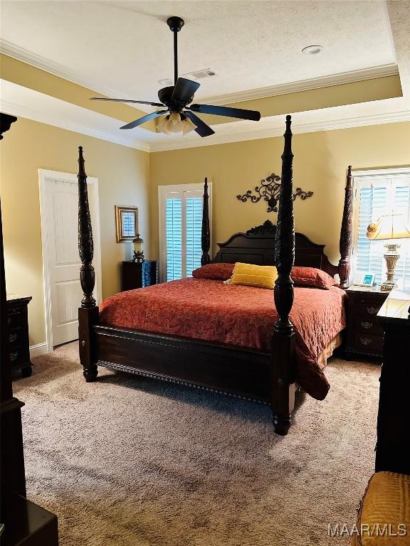 bedroom with ceiling fan, ornamental molding, carpet floors, and multiple windows