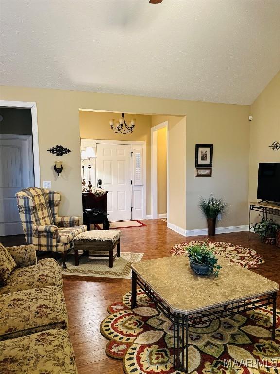 living room with an inviting chandelier and wood-type flooring