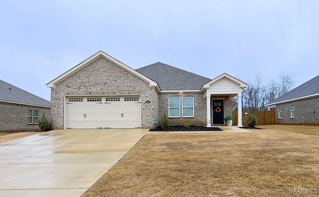 view of front of home with a garage and a front lawn