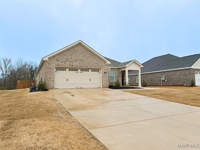 view of front of property featuring a garage and a front lawn