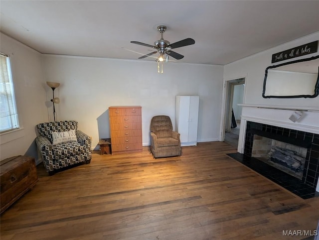 sitting room featuring hardwood / wood-style floors, a fireplace, and ceiling fan