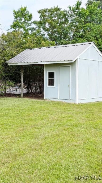 view of outbuilding featuring a yard