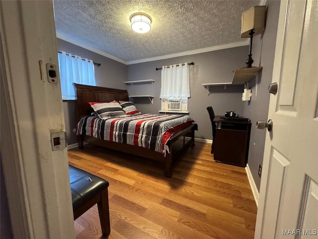 bedroom featuring crown molding, a textured ceiling, and light hardwood / wood-style flooring