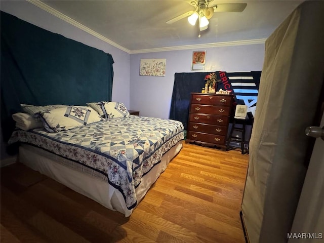 bedroom with ornamental molding, hardwood / wood-style floors, and ceiling fan