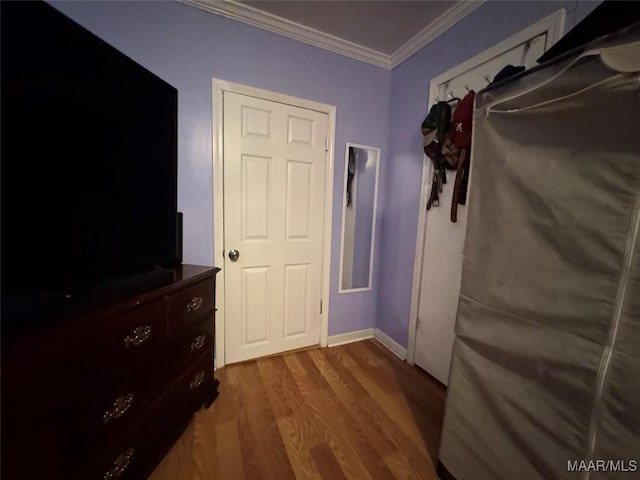 interior space with dark hardwood / wood-style flooring and ornamental molding