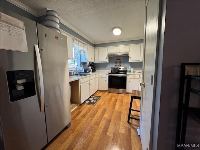 kitchen featuring sink, white cabinetry, stainless steel appliances, a textured ceiling, and light wood-type flooring