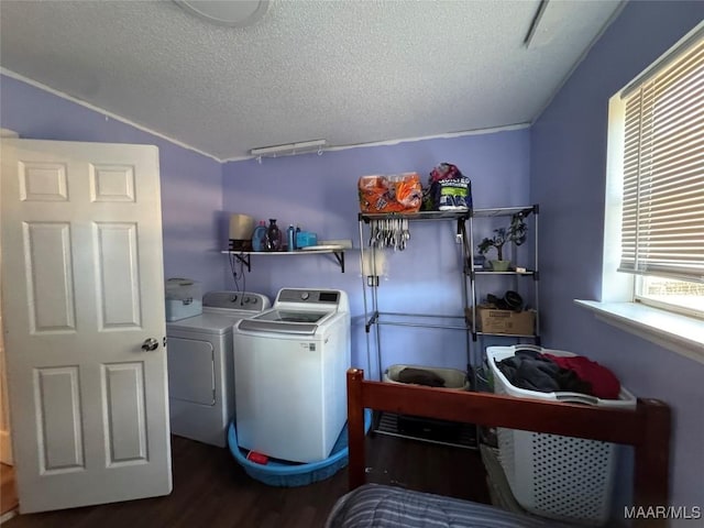 laundry area featuring wood-type flooring, independent washer and dryer, and a textured ceiling