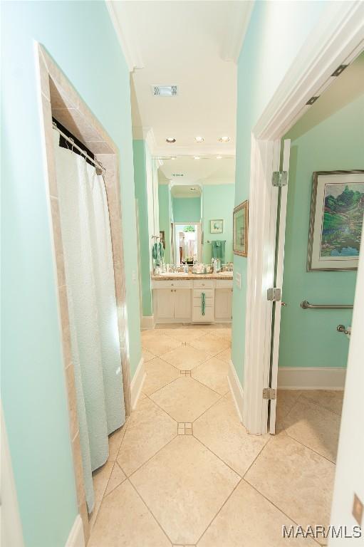 bathroom featuring a shower with curtain, crown molding, tile patterned floors, and vanity