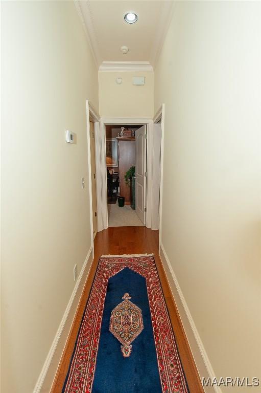 hall with hardwood / wood-style floors and crown molding